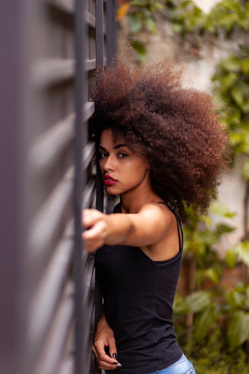 Free Woman Leaning Against Gray Wall Stock Photo