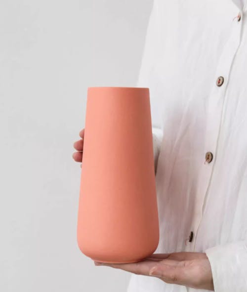 Close-up of a Person Holding a Minimalist Pink Vase