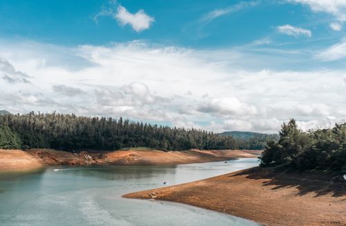 Free Breathtaking view of a serene river winding through lush forests in Ooty, TN, India. Stock Photo