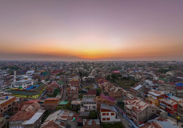 Captivating aerial view of Srinagar cityscape at sunset with vibrant colors and urban architecture.