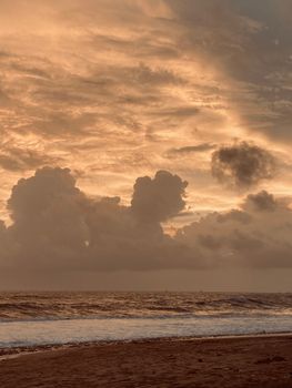 Beautiful sunset over the ocean at Chorwad Beach, India, with stunning cloud formations.