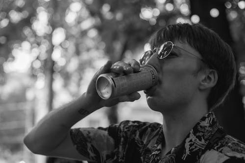 Man Drinking from Can in Black and White