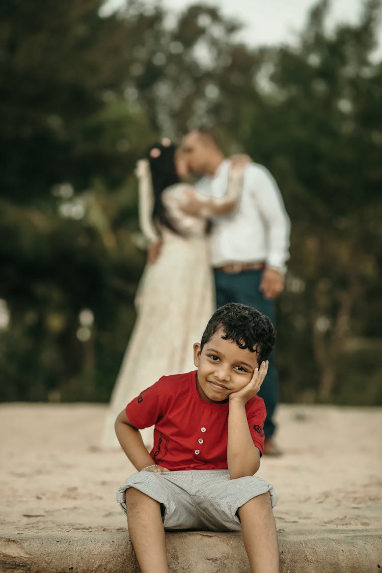 Boy With Newlywed Couple In Background