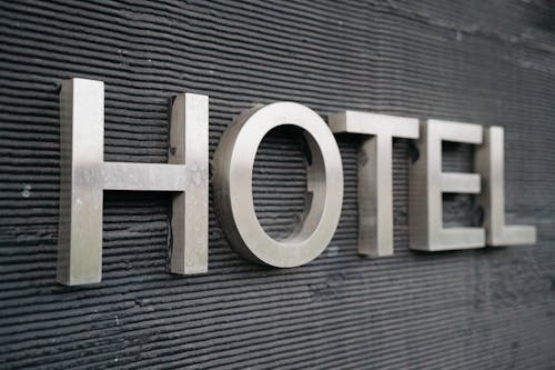 A hotel sign with the word hotel in silver