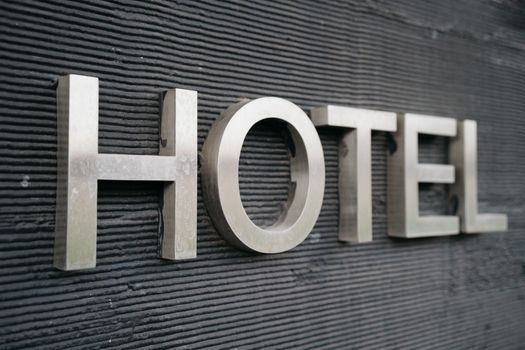 A hotel sign with the word hotel in silver