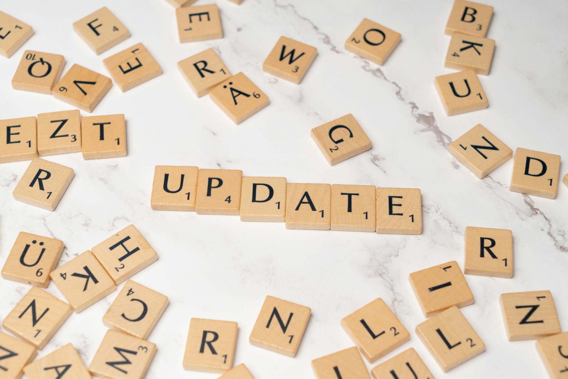 Scrabble letters spelling the word update on a white table