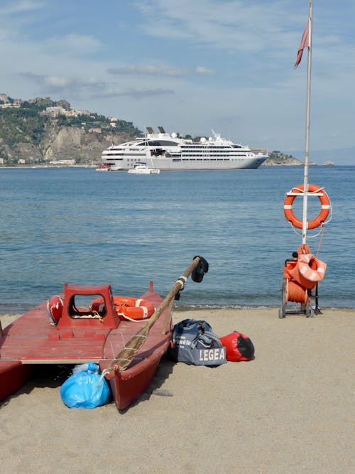 Rescue Boat on the Beach and Cruise Ship at Sea 