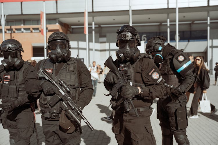 Group Of Armed Men In Black Cosplay Uniform Of Umbrella Corporation