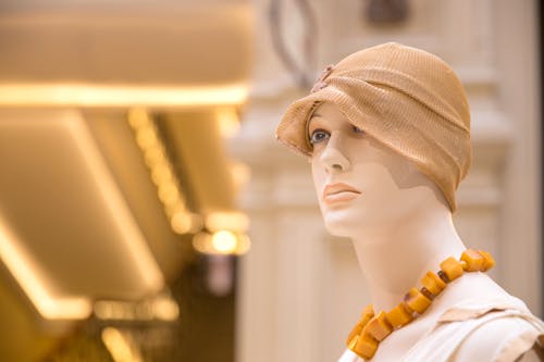 A Mannequin Wearing a Headdress and Necklace 