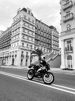 Motorcycle on an empty street in Baku, Azerbaijan with stunning architecture in black and white.