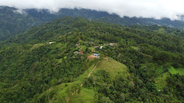 Aerial Panorama Of A Village On A Green Mountain