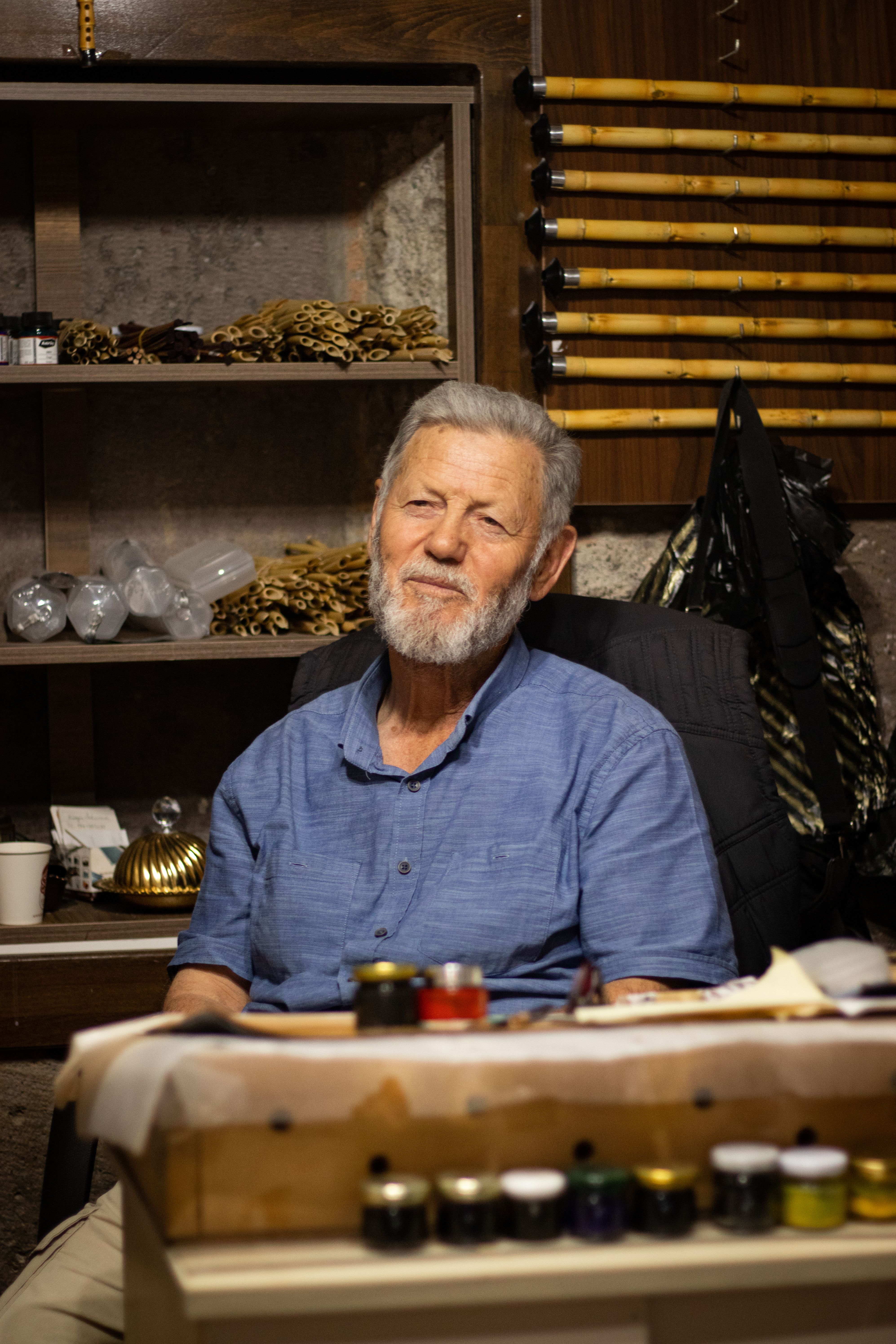 Portrait of a senior man with a beard sitting in a workshop in Kayseri, Türkiye.