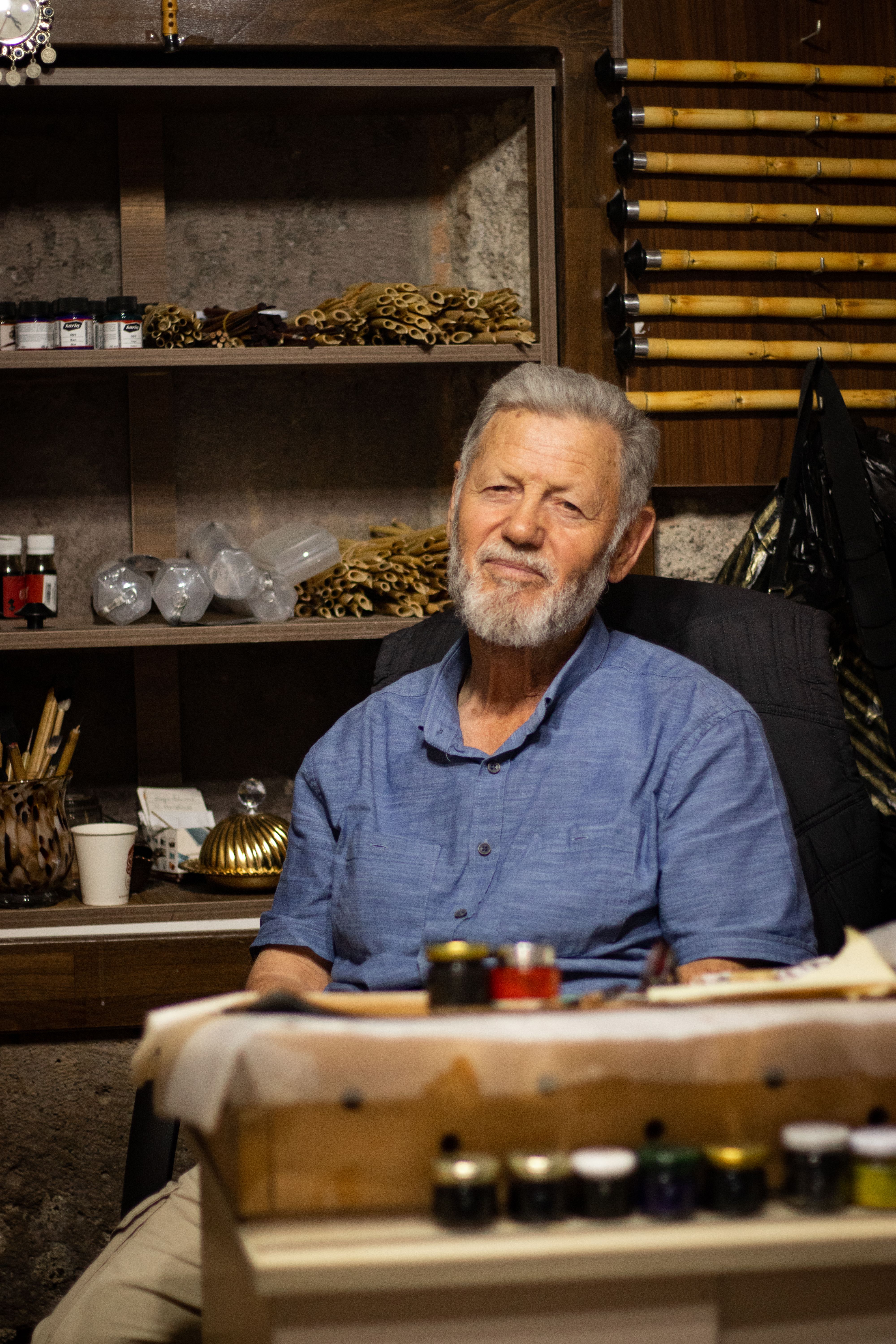Senior man with beard in a workshop setting, Kayseri, Türkiye. Craftsmanship tools visible.