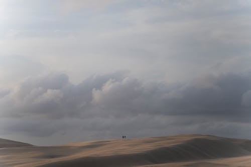 People Walking in the Desert in Distance