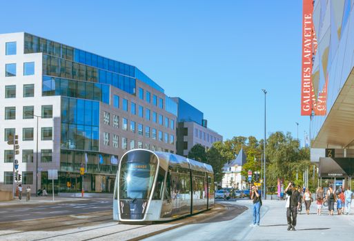 A scenic view of modern tram and urban architecture in Luxembourg city streets.