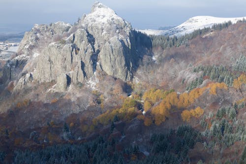 Snow on Rocky Peak among Forest