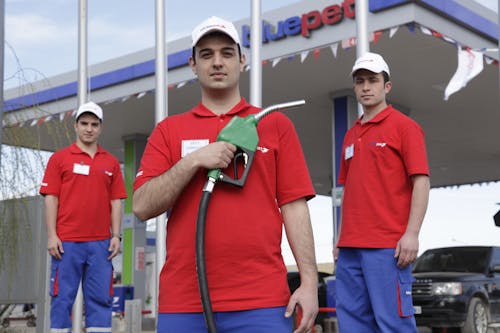 Men Posing at a Gas Station