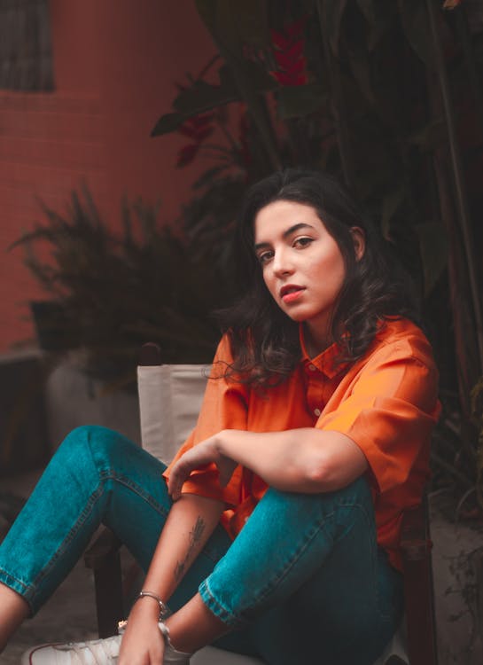 Woman Sitting on Brown Armchair