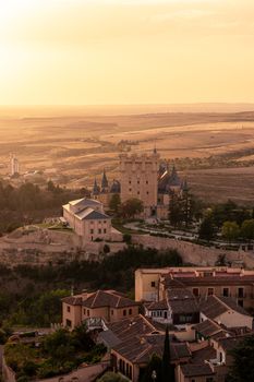 A stunning aerial view of Alcázar of Segovia at sunset, capturing its medieval beauty and surrounding landscape.