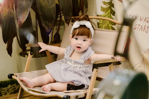 Girl in Dress Sitting on Chair