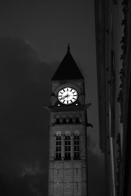 Free A dramatic black and white image of a historic clock tower at night, emphasizing architectural details. Stock Photo