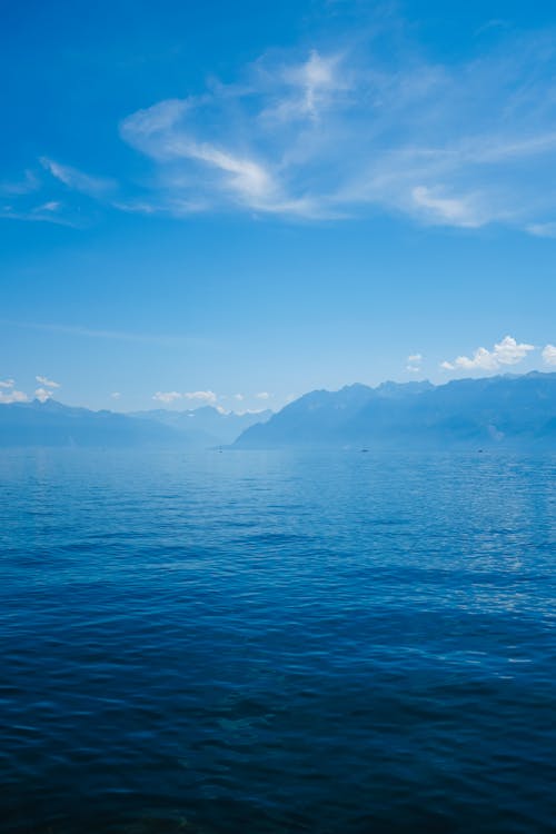 A blue sky with mountains in the background