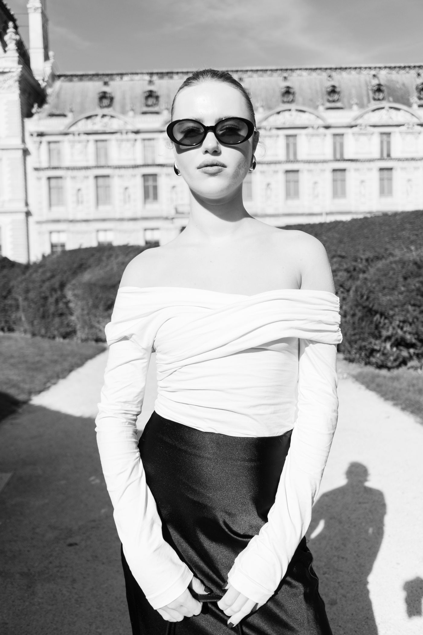 A black and white portrait of a woman in statement sunglasses — editorial eyewear glamour
