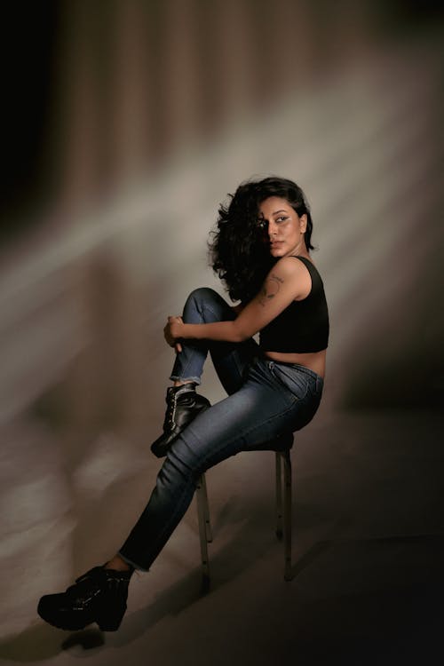 Brunette Posing in Jeans and Trainers