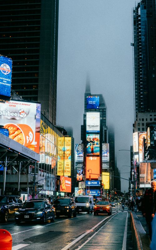 Free Illuminated billboards and bustling traffic in Times Square, New York, at twilight showcasing urban energy. Stock Photo