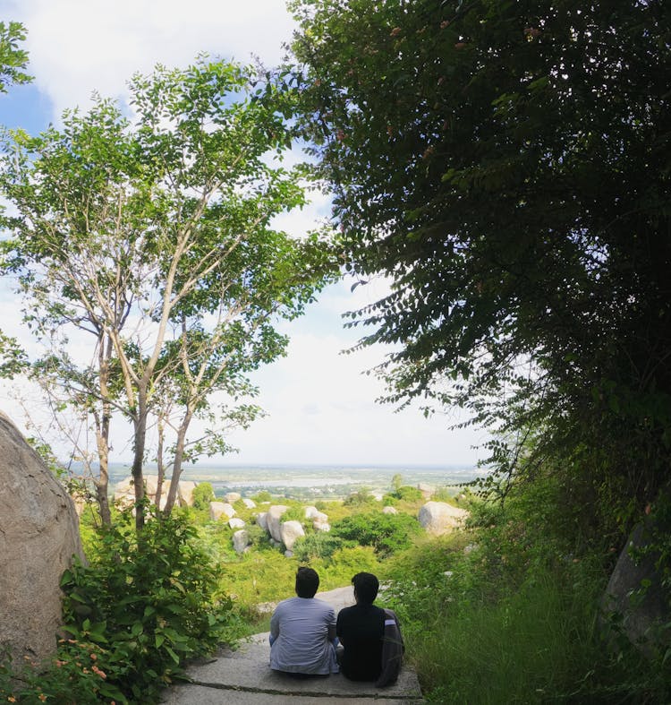 People Relaxing On Trail In Summer Scenery