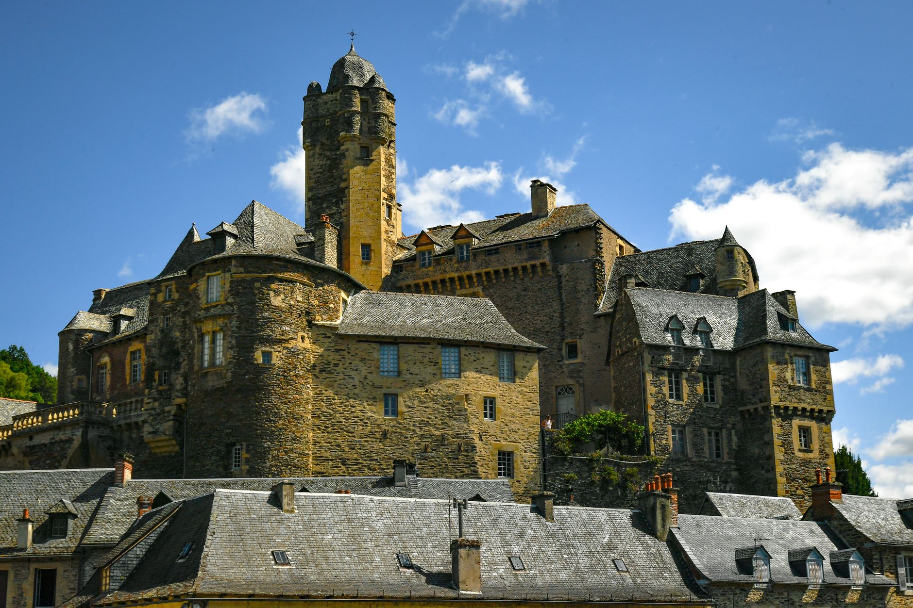 Historic medieval castle in Estaing, Occitanie, on a sunny day.