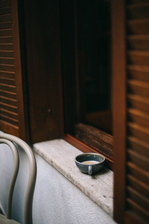 Cup with Beverage on Windowsill