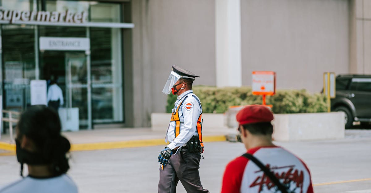 Security Guard Walking on Street near Building in City · Free Stock Photo