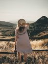 Selective Focus Photography of Woman Holding Brown Straw Hat
