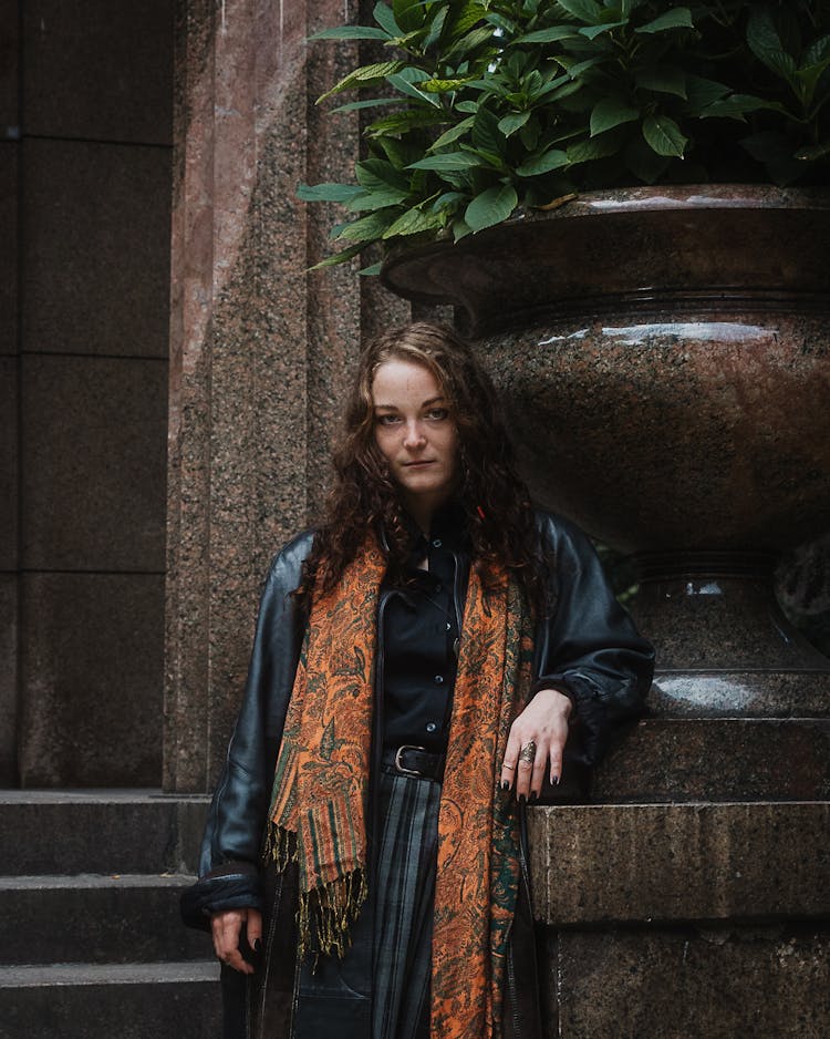 Woman In Leather Coat And Scarf