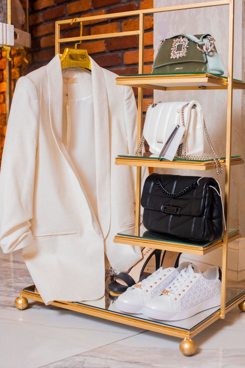 Stylish ensemble with white jacket and luxury handbags