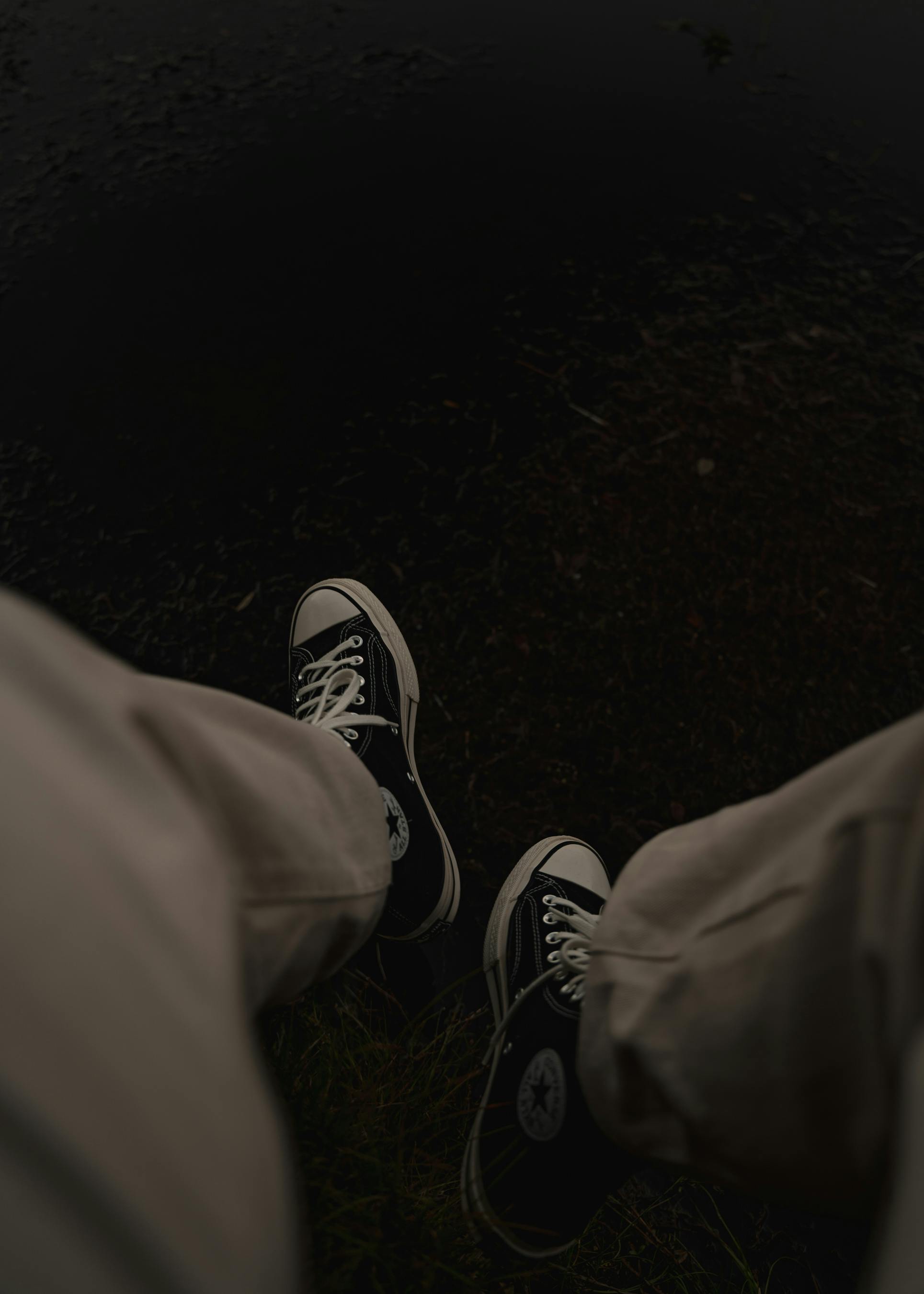 Person wearing sneakers near water, showcasing a relaxed vibe in Glenorchy, New Zealand.