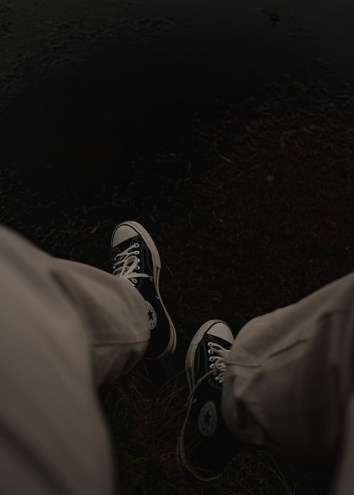 Free Person wearing sneakers near water, showcasing a relaxed vibe in Glenorchy, New Zealand. Stock Photo