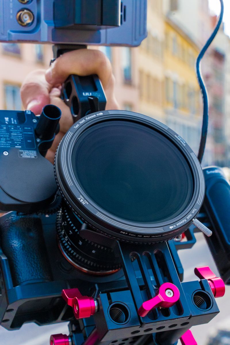 Camera Man With Video Camera on Tripod Position by the Street Across ...
