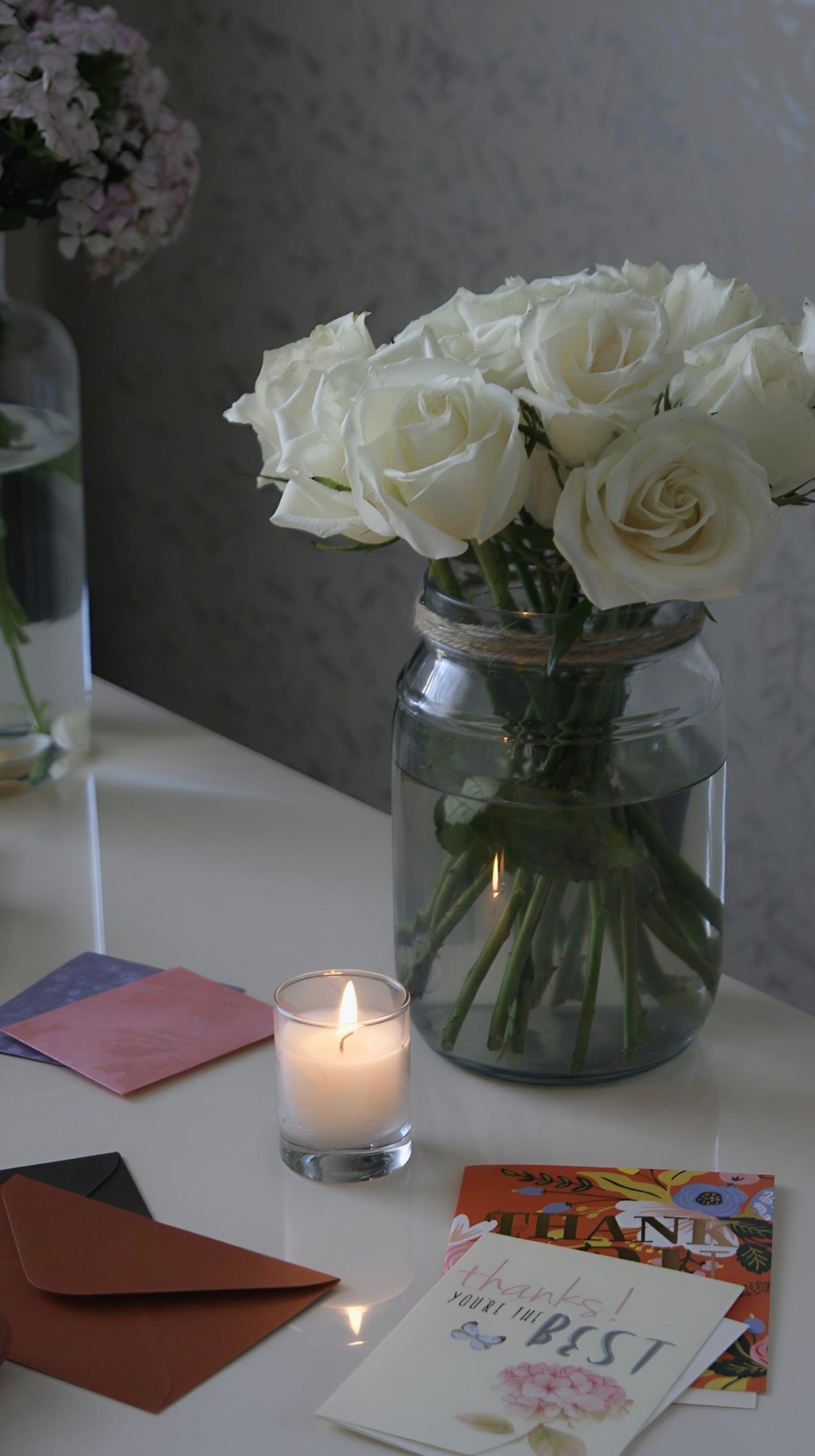 Flowers candles and lifestyle gifts on table