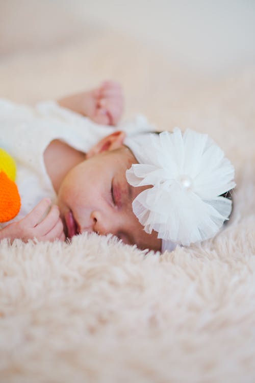 Free A Newborn Baby Lying on a Blanket  Stock Photo