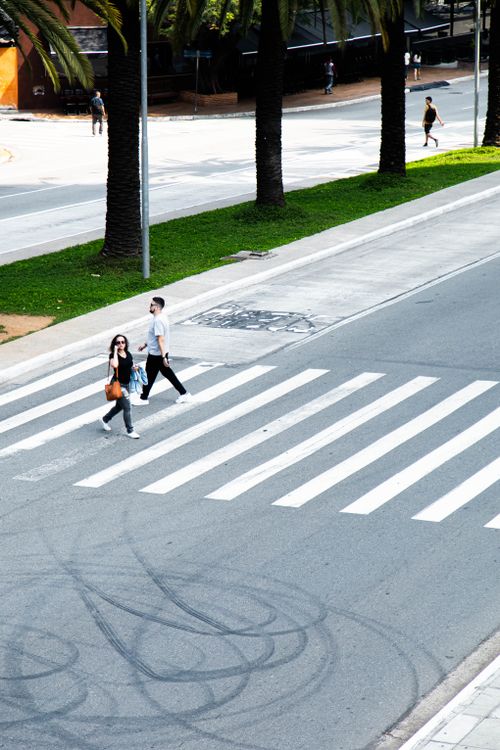 Free High angle view of a crosswalk in a city with people walking, offering a sense of urban life. Stock Photo