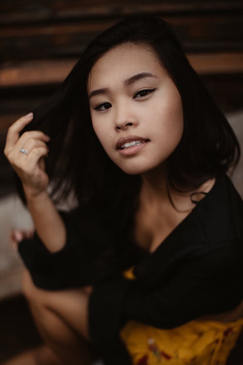 Selective Focus Photography of Woman Holding Her Hair