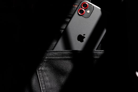 A close-up image of a smartphone partially visible in a black jeans pocket, showcasing modern gadget aesthetics.