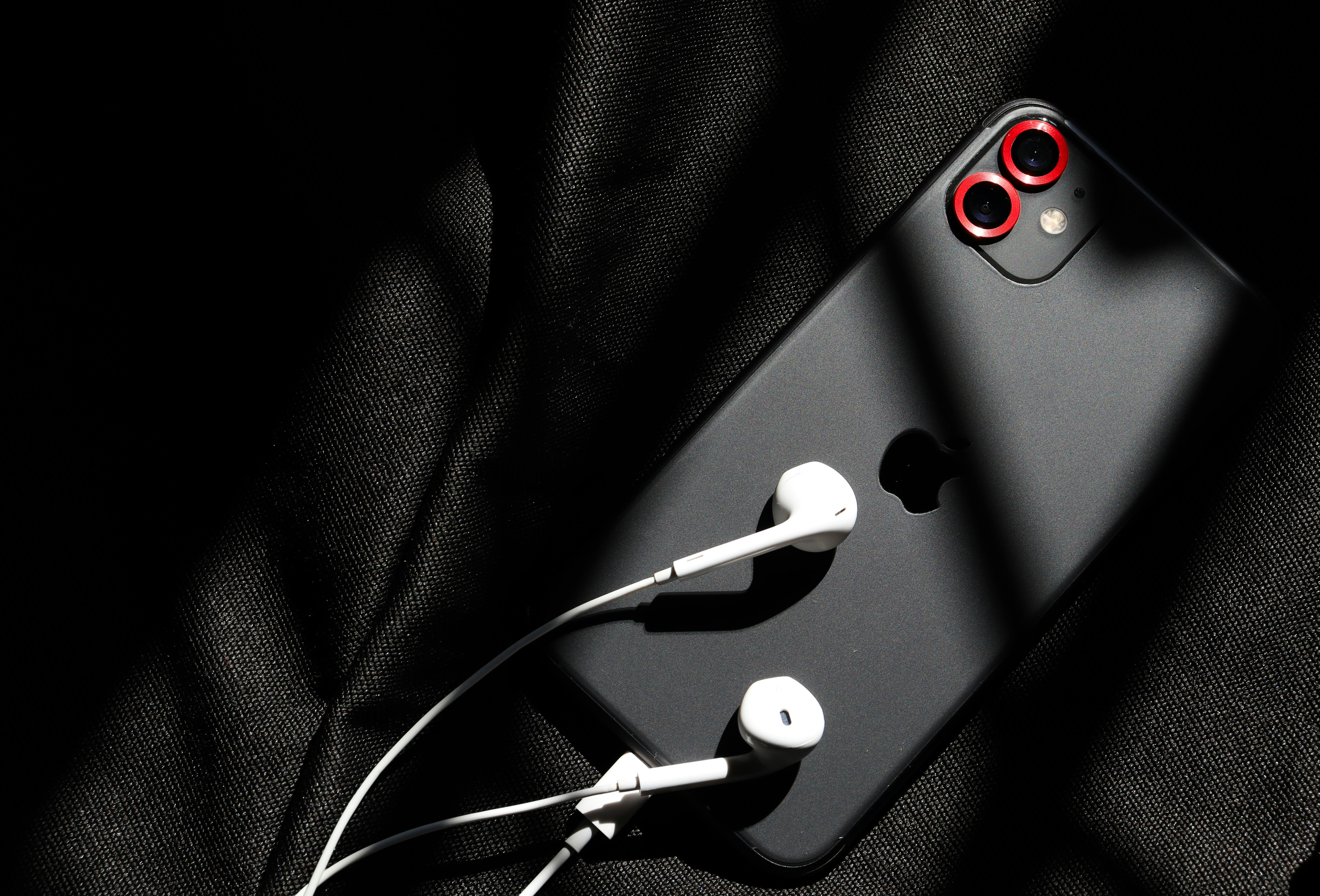 Black smartphone with subtle outline light on dark background