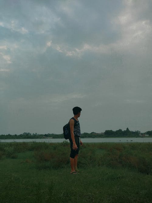 Man with Backpack on Grassland