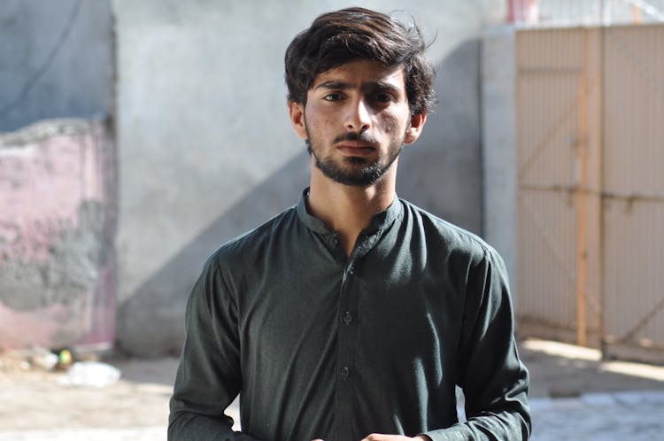 Young Man With A Stubble And Mustache Standing Outside 