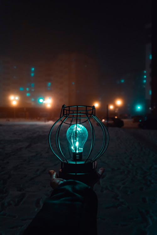 Free Person Holding Turned-on Light during Nighttime Stock Photo