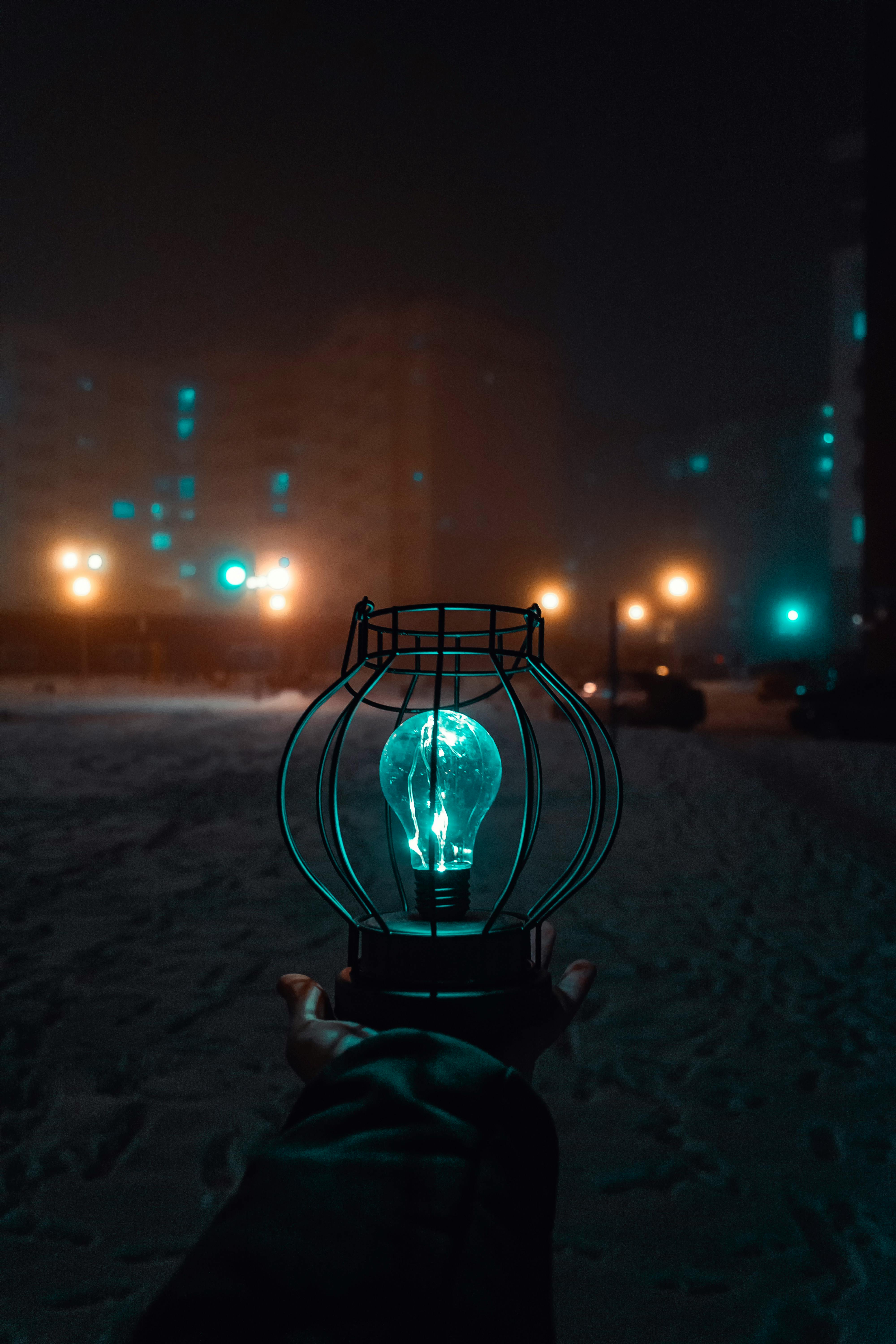 Person Holding Turned-on Light during Nighttime · Free Stock Photo