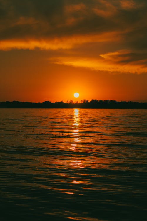 Lake under a Dramatic Sky at Sunset 